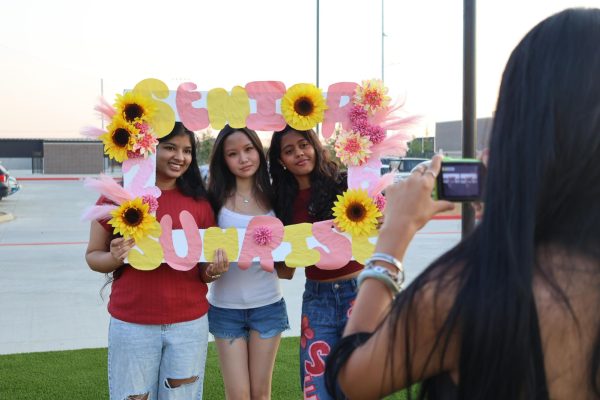 Taking a photograph with her friends, senior Gowri Santosh poses with her senior jeans. Santosh is most excited about senior sunset and senior skip day. "(My advice to freshmen) is to just like live instead of like always studying for once," Santosh said. "So yeah have fun."